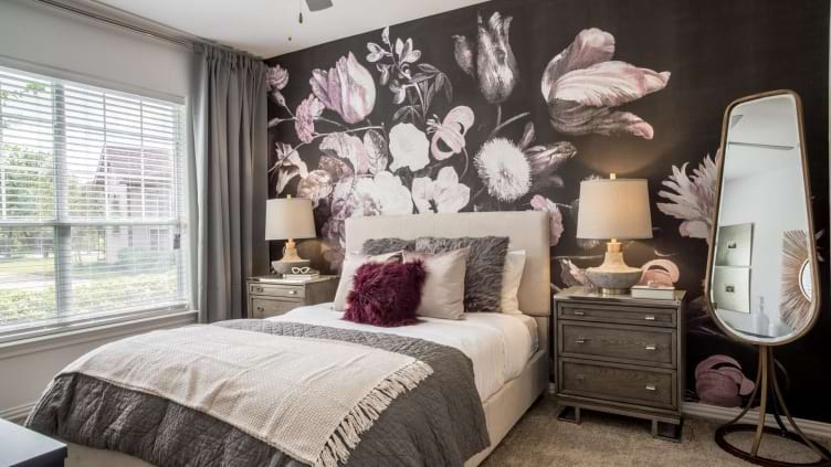 Apartment bedroom with floral accent wall